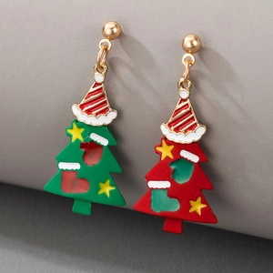 Close-up of asymmetric Christmas tree earrings with colorful enamel and holiday charms