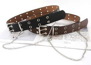 Detail of black and brown punk belts with double grommets and detachable silver chains