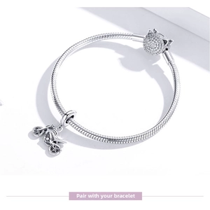 Detail of s925 silver snake chain bracelet with a motorcycle charm and zircon bead
