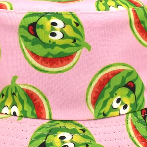 Detailed close-up of pink bucket hat featuring cartoon watermelon print and precision stitching