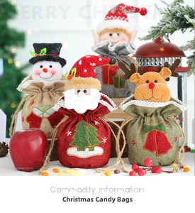 Detailed view of four burlap Christmas candy bags with classic 3D holiday characters