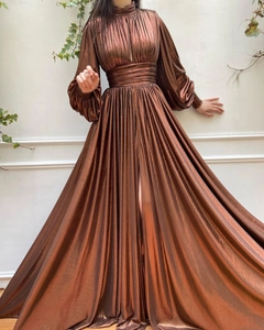 Detail of metallic bronze pleated maxi dress showing waist cinching and long puff sleeves