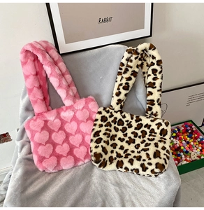 Detail of pink heart-pattern and leopard print plush tote bags with soft fur texture