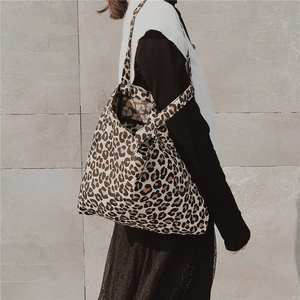 Leopard print canvas tote bag shown on model for a stylish shoulder-carry look
