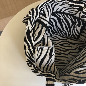 Detail view of the interior lining and pocket of the zebra print canvas tote bag