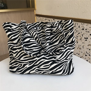 Macro shot of zebra pattern jacquard texture and durable canvas strap on tote bag