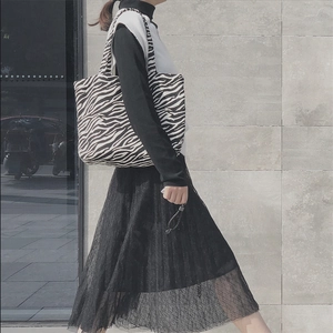 Outdoor model showcasing zebra print canvas tote bag with large storage capacity