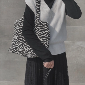 Detail view of Zebra pattern canvas tote bag styled with a minimalist outfit