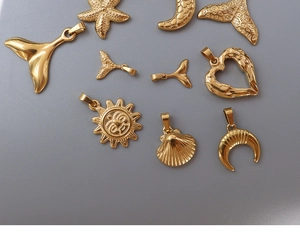Detailed close-up of 18k gold plated stainless steel pendants in star and moon shapes