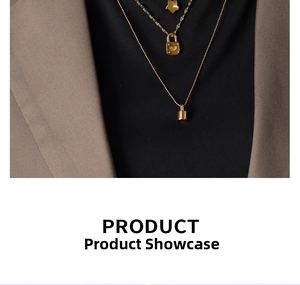 Detail of layered gold necklaces featuring heart lock and star pendants on a model