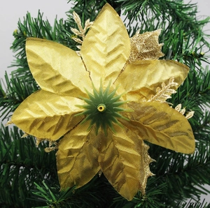 Close-up of golden glitter artificial Christmas flower with detailed fabric petals