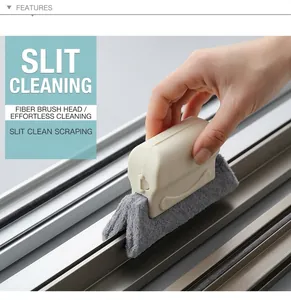 Close-up of scouring pad brush head cleaning dirt from narrow window track grooves