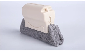 Detail view of window groove cleaning brush with beige handle and grey scouring pad