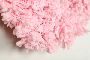 Macro view of soft pink flocked texture on decorative Christmas wreath elements