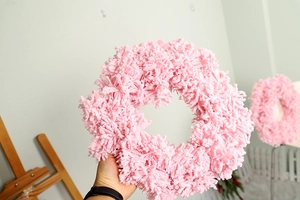 Detail shot of pink flocked Christmas wreath featuring soft chenille texture for decor