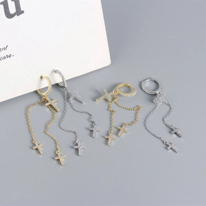 Detail of S925 silver cross drop earrings with cubic zirconia and tassel chain