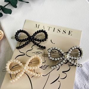 Three-piece set of elegant bead-woven bow hair clips in black, white, and champagne tones