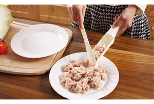 Detail showing white plastic meatball maker tool kit being used to portion meat