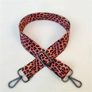 Detail view of leopard print bag strap with gunmetal lobster clasp and adjustment buckle