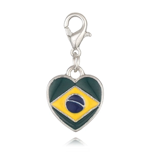 Macro detail of heart-shaped charm with Brazil flag pattern and silver lobster clasp