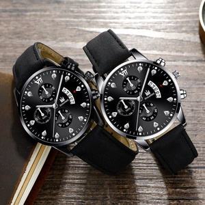 Detailed view of dual men's business watches with Roman numerals on dark wood background