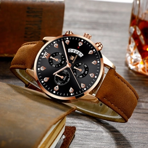 Detail of rose gold business watch with Roman diamond scales and brown leather strap