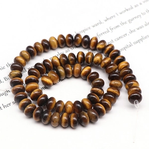 Macro shot of natural tiger eye abacus beads in brown stripes for DIY jewelry making