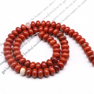 Macro shot of red jasper abacus beads showing natural stone texture for DIY jewelry