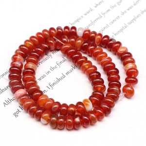 Macro shot of smooth orange-red carnelian abacus beads for DIY jewelry making