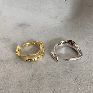 Close-up of S925 sterling silver stamp on irregular liquid gold and silver rings