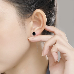 Detail of minimalist S925 sterling silver ear threader with a round black gemstone