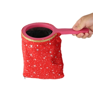 Detail of magic trick bag with red velvet star fabric and golden rimmed handle