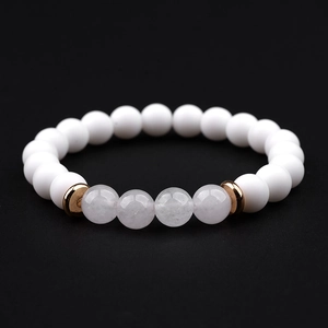 Detail of white matte stones and lavender crystal beads on a stretch bracelet