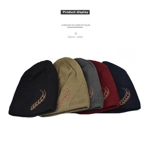 Detailed view of wheat embroidery and fine knit texture on winter hats in five colors