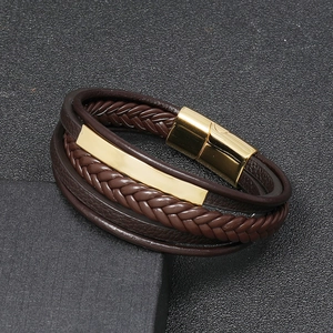 Macro view of multi-layer woven leather men's bracelet with gold magnetic buckle