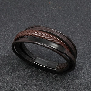 Close-up of men's multilayer braided leather bracelet with black magnetic steel clasp