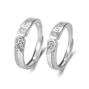 Silver couples rings with zircon stones and Forever Love engraving on white background