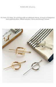 Detail of elegant geometric metal hairpins with hammered texture in gold and silver finish