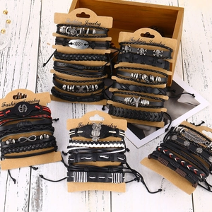 Detail of multi-layer leather bracelets set with retro punk alloy skull charms