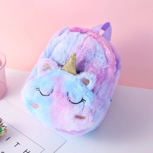 Close-up of fluffy unicorn backpack showing pink purple gradient fur and gold glitter horn