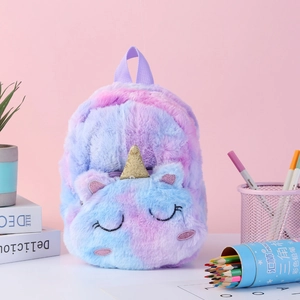 Detail view of unicorn plush backpack featuring gradient long fur and golden horn