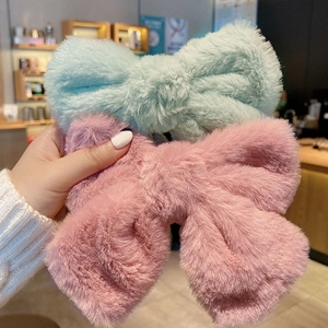 Large plush bow hair clips in mint green and pink for autumn and winter hairstyles