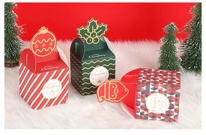 Close-up of assorted festive Christmas gift boxes with decorative handles and gold patterns