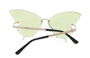 Detailed back view of rimless butterfly sunglasses with green lenses and gold chain temples