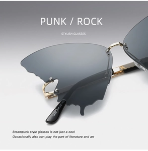 Detailed macro view of butterfly shaped grey gradient lenses with gold metal rivets