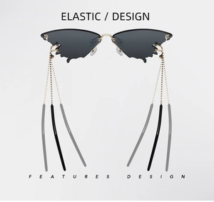 Close-up of butterfly wing shaped rimless sunglasses with gold chain detail