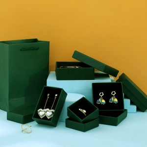 Dark green jewelry gift box set with matching paper bags and elegant ring cases