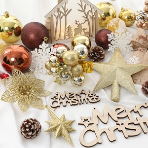 Christmas tree ornaments set with gold and red baubles, wooden reindeer, and glitter stars