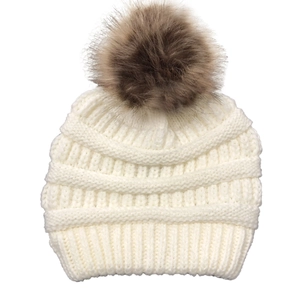 Detail of cream knit beanie with brown faux fur pompom and thick woven texture