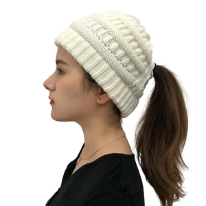 Detail showing the practical ponytail hole design on this white knitted winter beanie hat